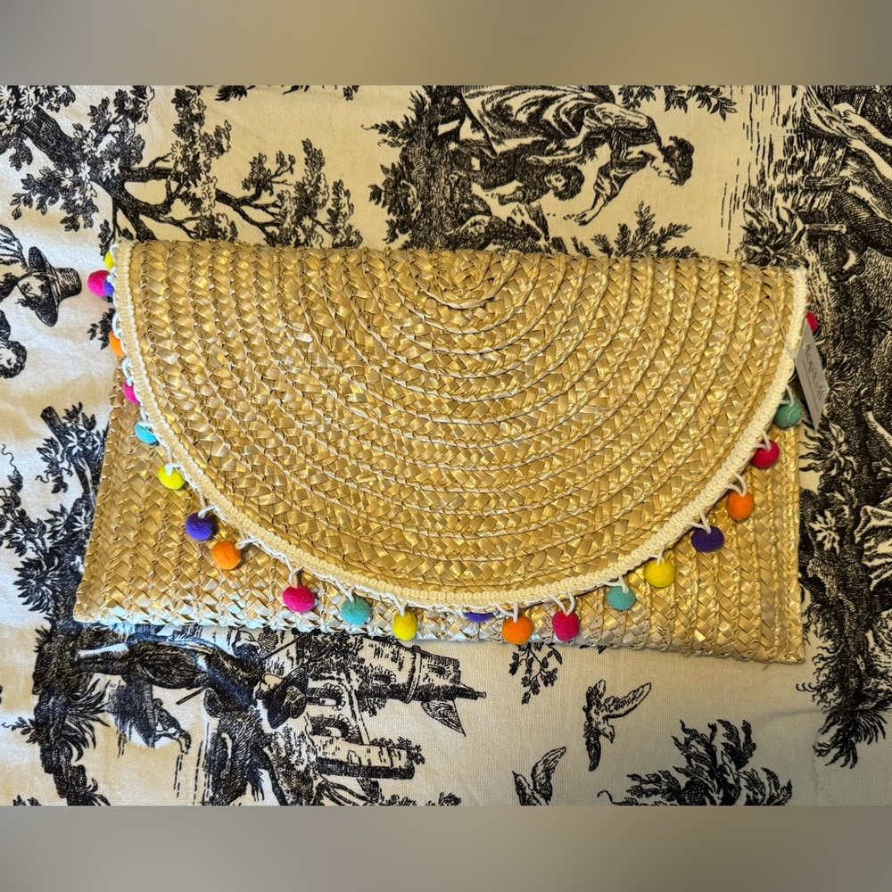 NWT rattan clutch with colorful Pom Pom trim